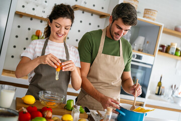 Secret ingredient is love. Couple preparing a healthy meal together while spending free time at home