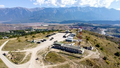 Aerial View of Military Base with Vehicles, Radar and Communication Towers
