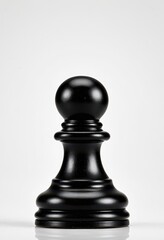 Elegant black chess pawn on a minimalist backdrop, perfect for strategy and gaming themes.