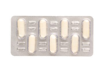 Medical pills in blister packaging, close-up, isolated on white background.