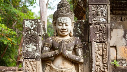 Fototapeta premium Ancient Khmer Warrior Sculpture in Stone Carved Armor at Angkor Wat