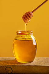 Natural honey on yellow background with space for text