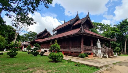 Serene Myanmarese Teak Monastery Complex Surrounded by Lush Greenery