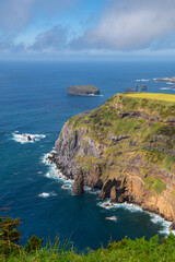 View of Atlantic ocean coastline of São Miguel island from Miradouro da Ponta do Escalvado, Azores, Portugal. Rocks and sea. Nature, landscape photography at sunny day.
