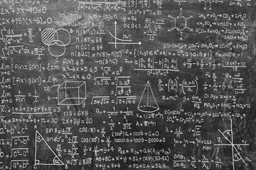 Wide blackboard inscribed with scientific formulas and calculations in physics, mathematics and...