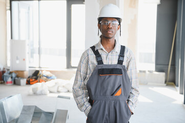 African american construction worker wearing safety equipment posing on construction site