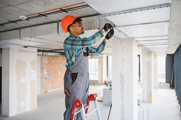 Arab installing ventilation system on construction site