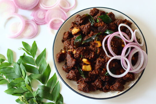 Kerala Beef Fry. A flavorful South Indian dish made by marinating beef with spices, slow-cooking it with onions