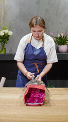 Florist unpacking a package of roses. Small business.  Close-Up.  Soft focus.