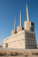 The imposing shutdown thermal power station at Sant Adria near Barcelona with its iconic three smoke stacks
