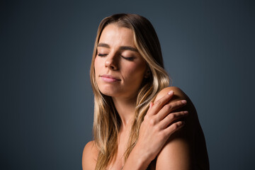 Charming woman with natural beauty and soft features exhibiting relaxation while showcasing radiant...