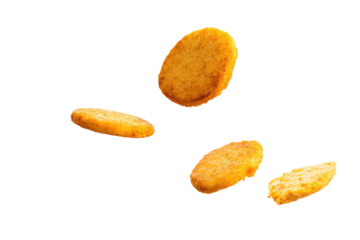 Four hash browns arranged in a scattered formation against a stark black background creating contrast on transparent background