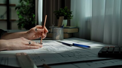 Hands Creating Architectural Blueprint with Tools and Pencil