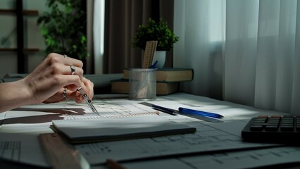 Hands Working on Architectural Blueprint with Precision Instruments