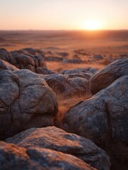 Ancient boulders bathed in the warm, golden light of a setting sun