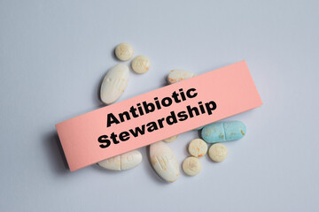 Concept of antibiotic stewardship write on sticky notes isolated on Wooden Table.