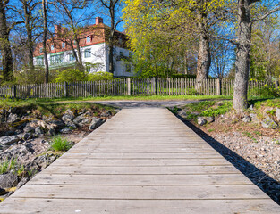 Scenic Wooden Dock Leading to a Charming House