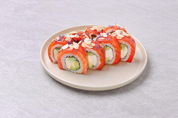 Salmon and Almond Sushi Roll with Avocado and Cream Cheese on Stone Plate
