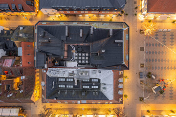 Aerial night view of a historic European city center with beautiful old architecture, illuminated...
