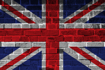 Fototapeta premium Big national flag of great britain on a massive old brick wall.