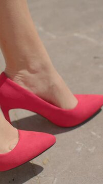 A closeup view of stylish pink high heels being worn by a model, beautifully showcasing fashionable and elegant footwear