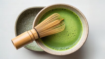 Matcha tea preparation with a bamboo whisk in a bowl on a light background. , Concept of Traditional Matcha Latte with Cultural Presentation.