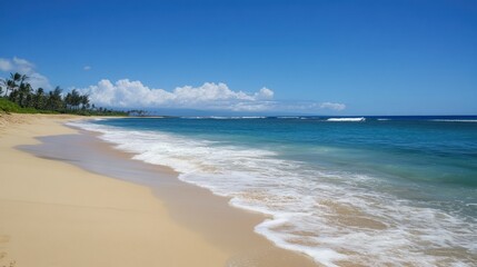 Serene beach view with turquoise water, golden sand, and a cloud-dotted sky.
