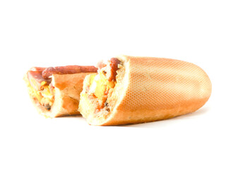 Traditional tasty Irish breakfast roll with white bread, sausage, bacon or rasher, fried egg and black pudding on greasy wrapping paper. Popular high calorie meal in Ireland. Classic dish