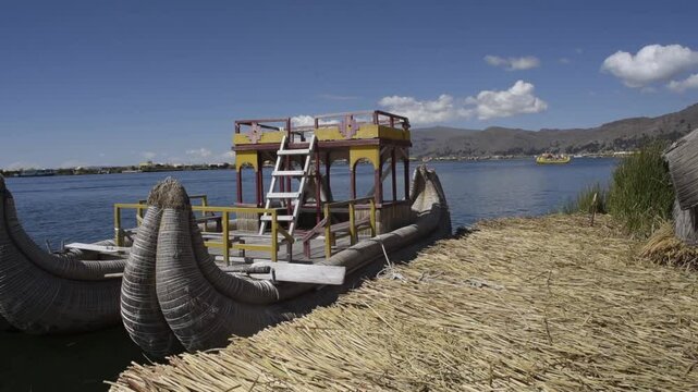 Peru Uros island with their typical colorful clothing hats skirts standing family The floating islands of the Uros artificial habitable surfaces built of totora, an aquatic plant that grows on the sur