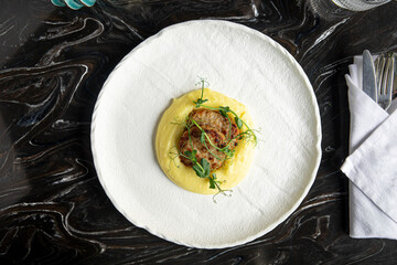 Portion of gourmet cutlets with mashed potato in restaurant