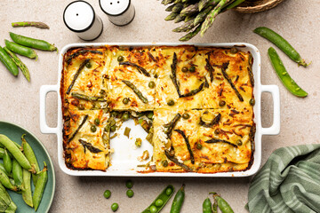 Top view of Spring Vegetable Lasagna - Lasagne primavera, with asparagus, peas, zucchini and aged ricotta cheese.
