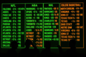 Neon-lit sports betting board with silhouettes of viewers