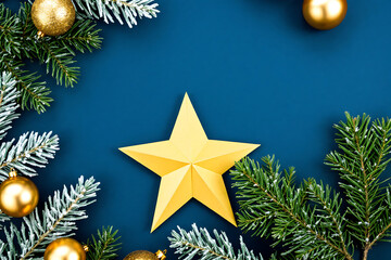 Golden star and christmas ornaments on dark blue background