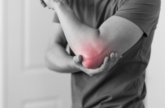 Man with elbow injury showing red highlights pain relief concept concept muscle pain due to lateral epicondylitis or tennis elbow injury, Health care concept 