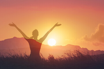 Young woman facing sunset rejoices, laughs, smiles looking up to the sky, enjoys life and summer, nature, happiness happy state of mind 
