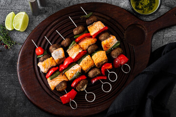 salmon skewers with vegetables and green sauce. summer barbecue recipe