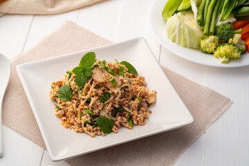 Thai spicy salad with Golden Needle Mushroom and minced chicken breast in white plate