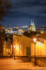 Strolling down the staircase of Prague Castle reveals a stunning view of the city bathed in golden...