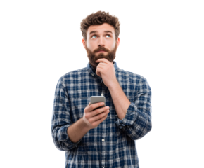 A man with a beard, holding a phone, looks up thoughtfully with hand on his chin.