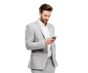 A well-dressed man in a gray suit intently checks his smartphone in a professional setting.