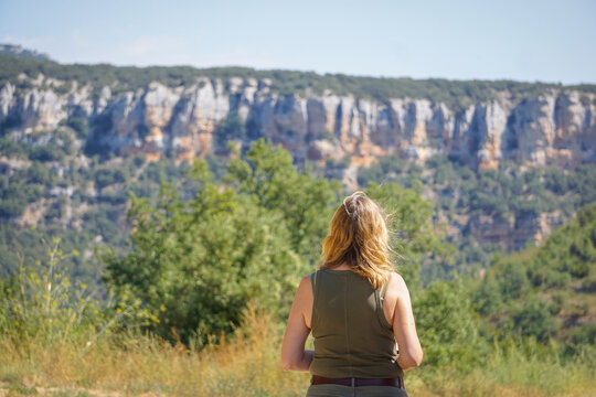 Young woman wearing a T-shirt and shorts contemplating the landscape and vegetation of the province of Burgos