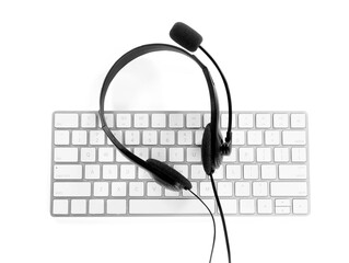 Headset with microphone and keyboard on white background, top view