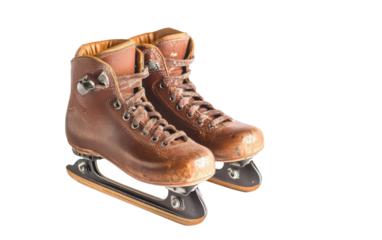 Two old brown skates with laces on a white background