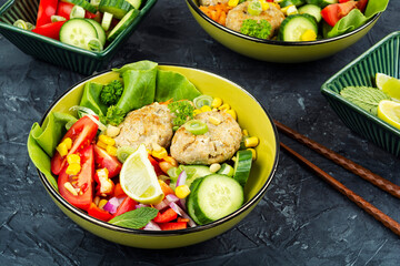 Buddha bowl with vegetables and fish cutlets.