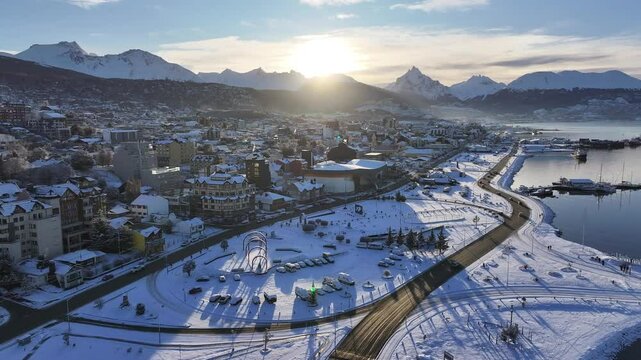 Ushuaia Skyline In Ushuaia Tierra Del Fuego Argentina. Birds Eye View Of Stunning Cityscape With Streets And Buildings. Sunset Snowing Illumination Glacial Landscape Snow Capped.
