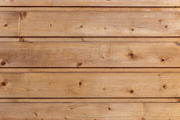 Obraz premium Light brown wooden planks arranged horizontally with visible wood grain and knots in a natural finish.