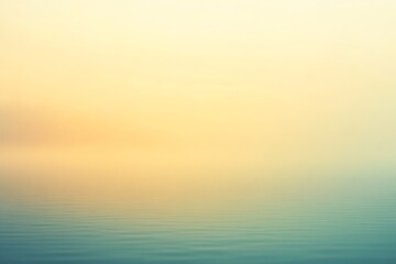 Tranquil landscape featuring a lake shrouded in soft, golden mist at sunrise, creating a serene and peaceful atmosphere