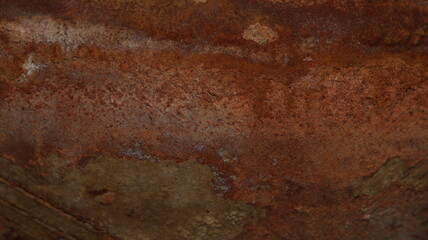 Textured rusted metal surface with reddish-brown corrosion