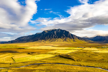 Aerial Iceland: Cloudy Skies Over Mountains and Meadows