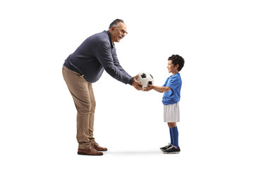 Mature man giving a football to a boy